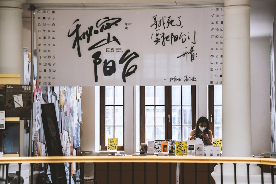 Black and white photo of General MacArthur signing Japanese constitution