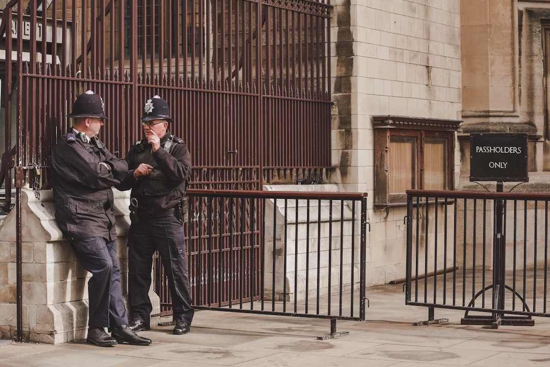 British police officers arresting a woman in a messy apartment