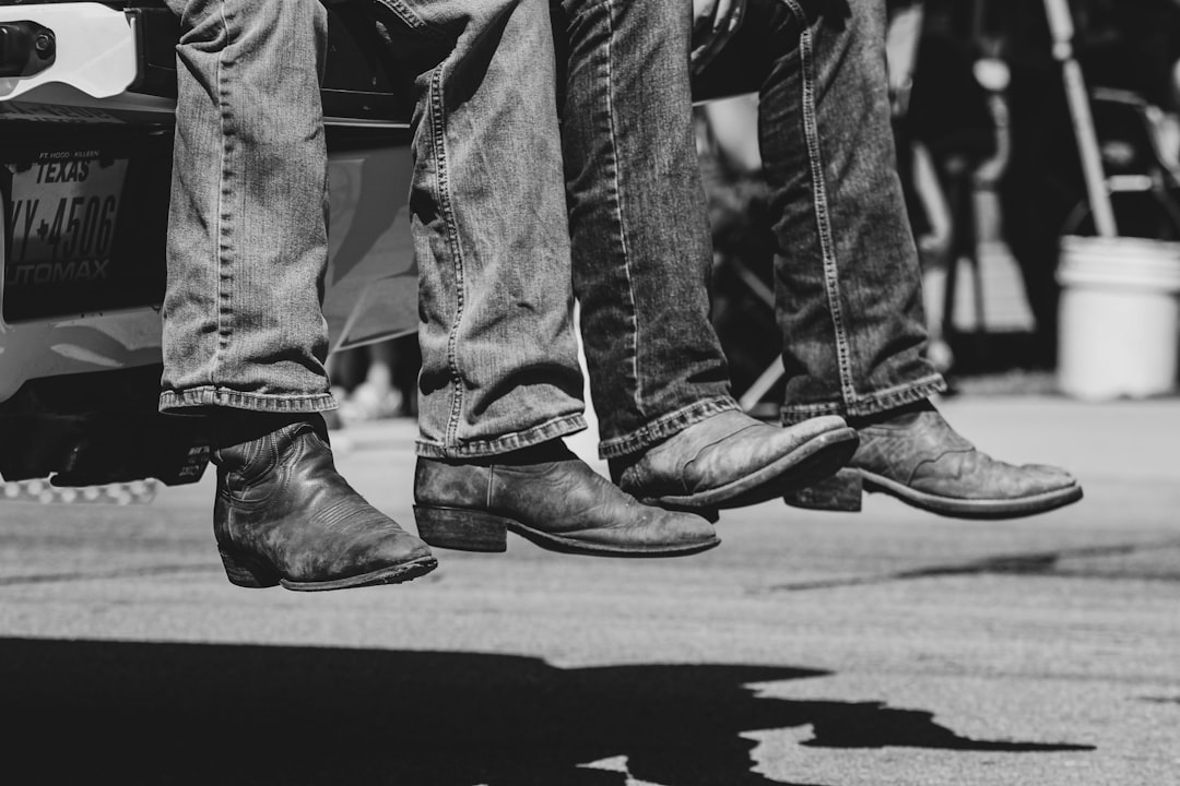 Group of women in cowboy boots line dancing at a Texas bar