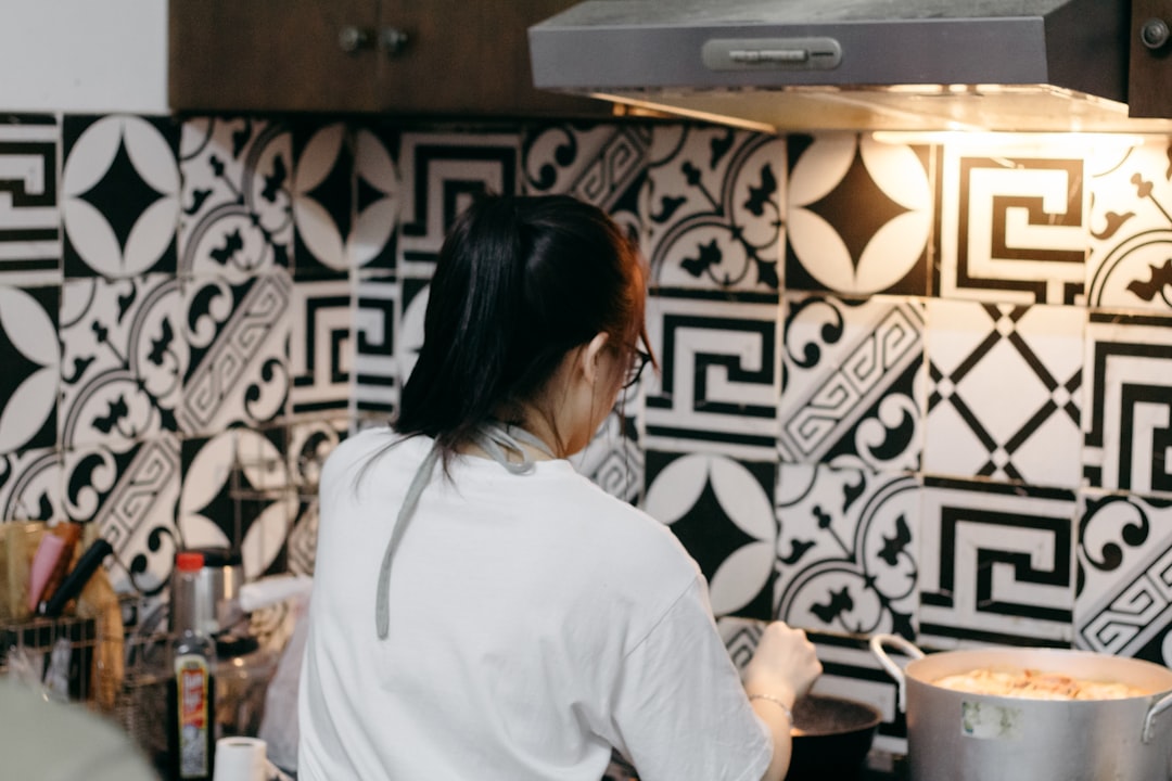 A person cooking a healthy looking meal in a bright, modern kitchen