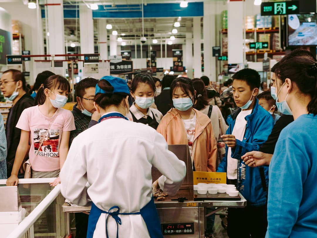 Panning shot of workers processing gold in a Shuibei factory in Shenzhen