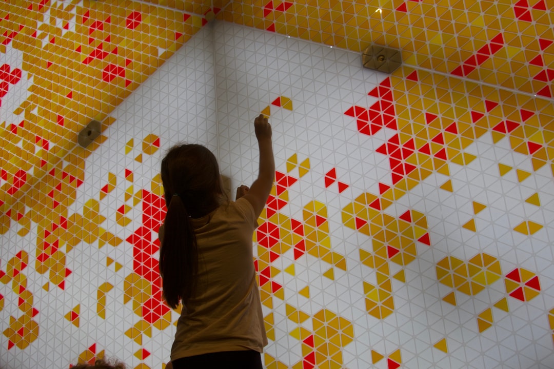 Close up of a wealthy Chinese investor inspecting a gold bar