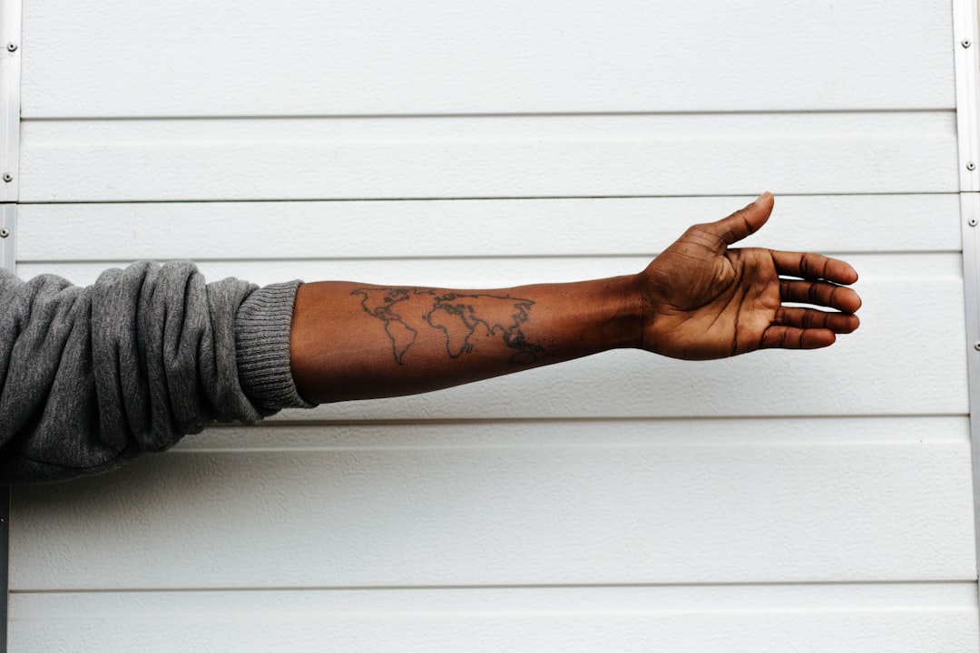 Close-up of a man's hands bound by iron shackles, emphasizing the feeling of confinement and injustice.