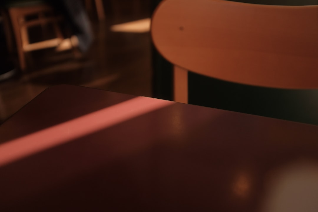 two people sitting across from each other at a table, a visible gap between them