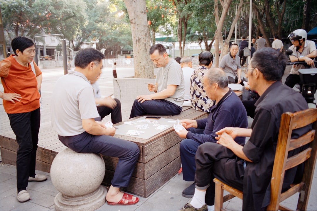 Group of chinese politicians in suits sitting at long table during a meeting