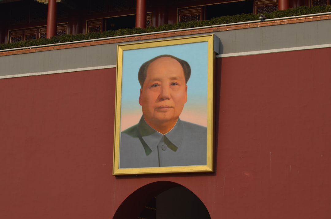 Chairman Mao portrait looking thoughtful, perhaps reviewing documents.