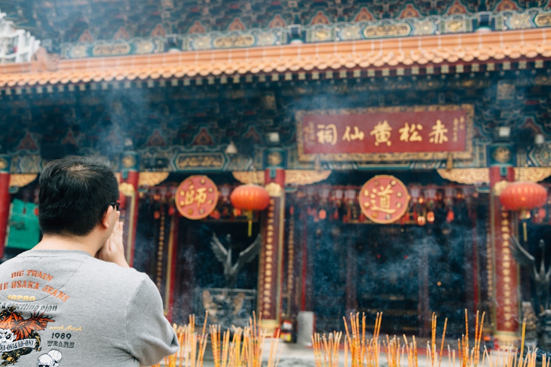 Man meditating in a temple with incense burning