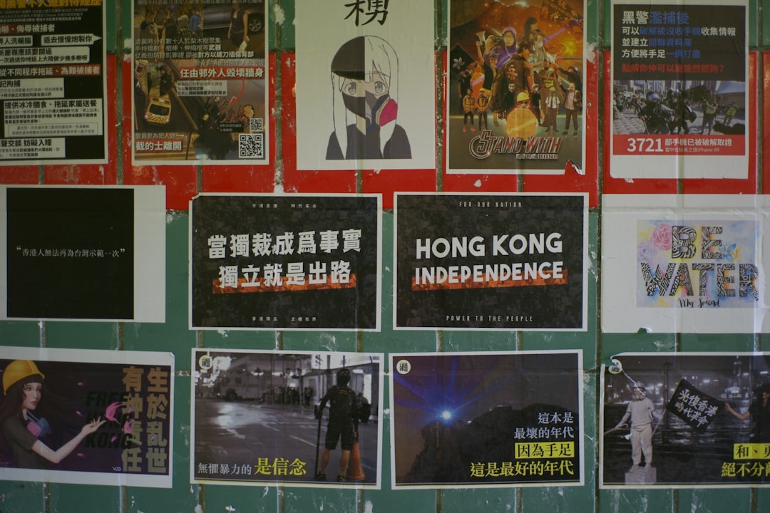 A propaganda poster featuring Wang Hongwen alongside other communist leaders, with a backdrop of revolutionary imagery.